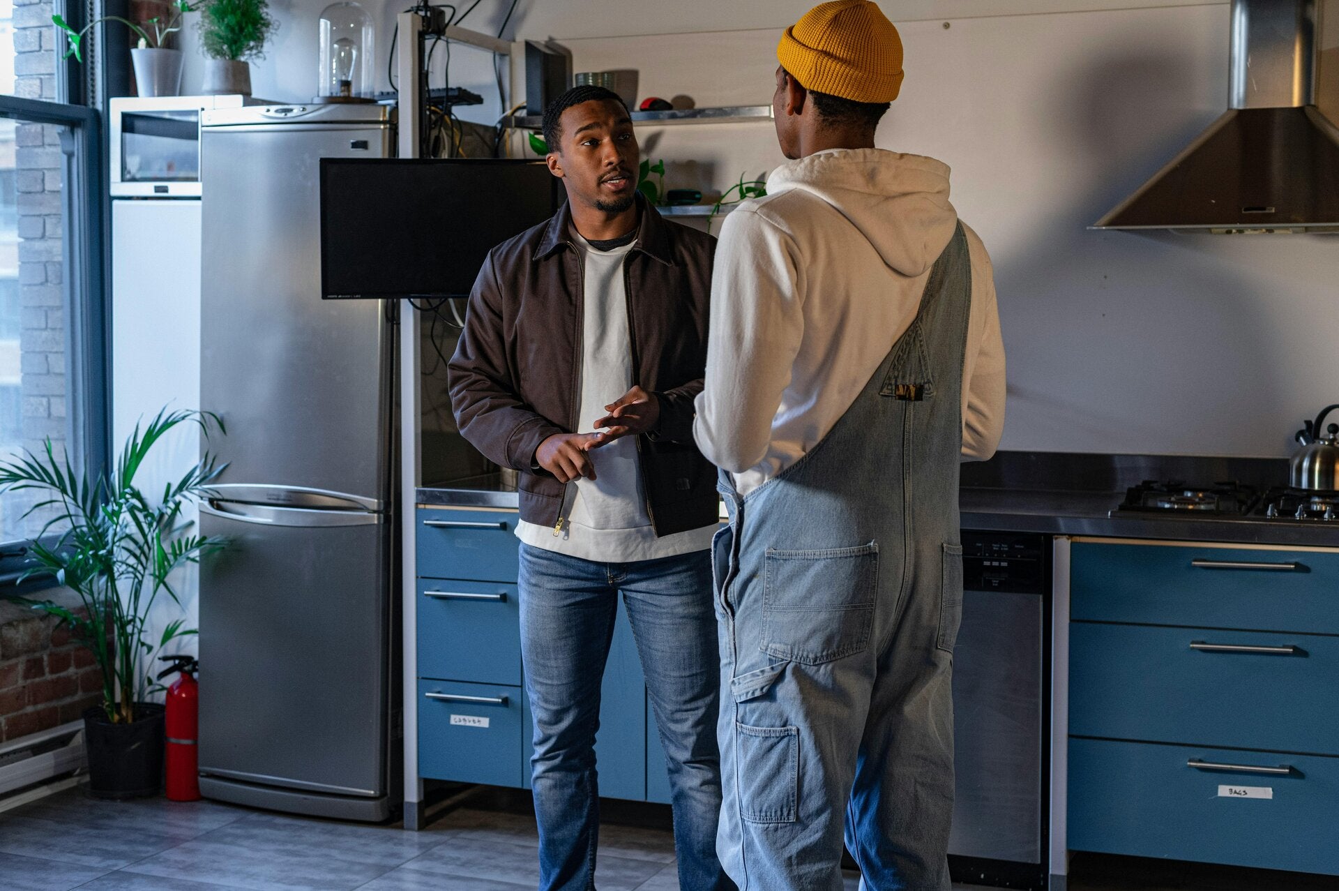 X.Q Electrical electrician discussing electrical work with a customer in a Doncaster kitchen